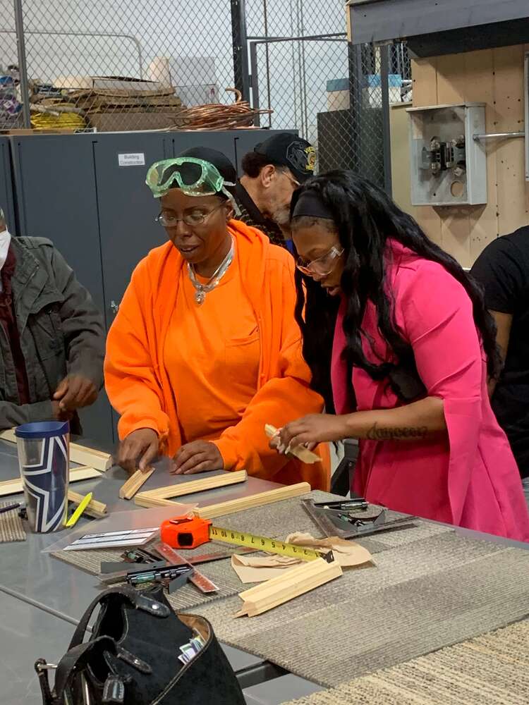 Students with goggles on cutting wood