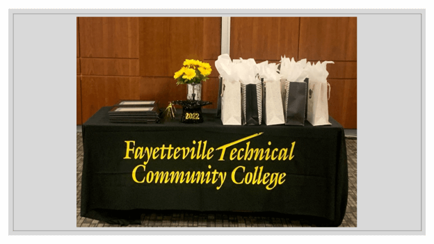 Fayetteville Technical Community College tables with flowers and gift bags on top