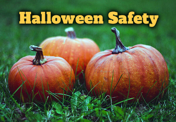 Three pumpkins sitting in the grass with text that reads Halloween Safety