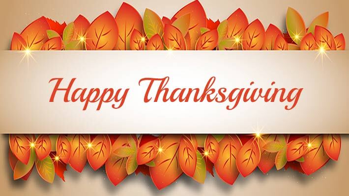 Leaves behind a banner that reads, Happy Thanksgiving.