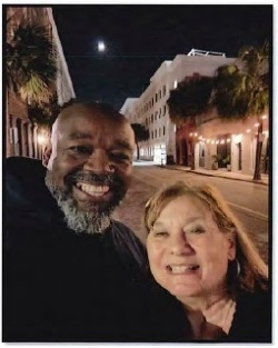 A couple standing outside in downtown Charleston.