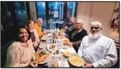 People sitting at a table with food.