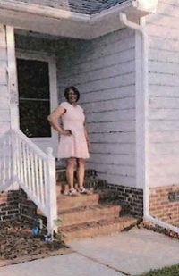 Tamiko Hill in front of her new house.