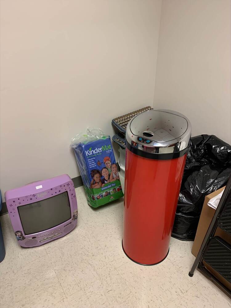 Various thrift store items displayed on the floor